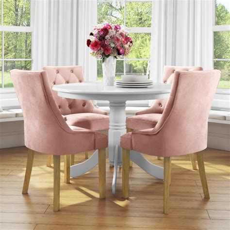 small  dining table  white   velvet chairs  pink bun