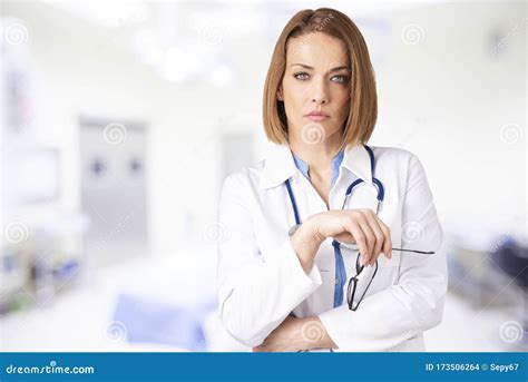 Attractive Middle Aged Female Doctor Standing In Doctor`s Room Stock