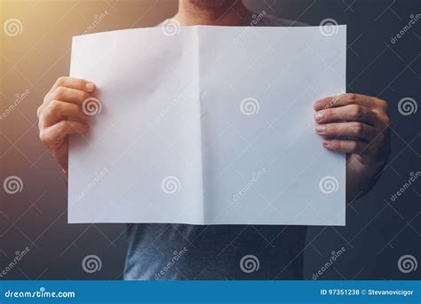 casual man holding blank  paper spread  copy space stock photo image  advertisement