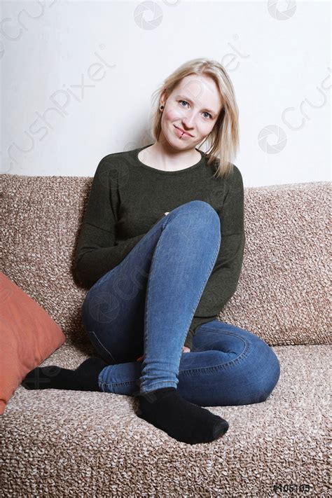 young woman sitting  sofa  home stock photo  crushpixel