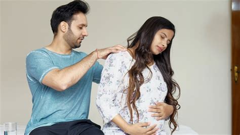 Husband Massages His Wife S Back During The Final Trimester Of
