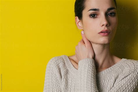 Portrait Of Young Woman Against Yellow Wall By Stocksy Contributor