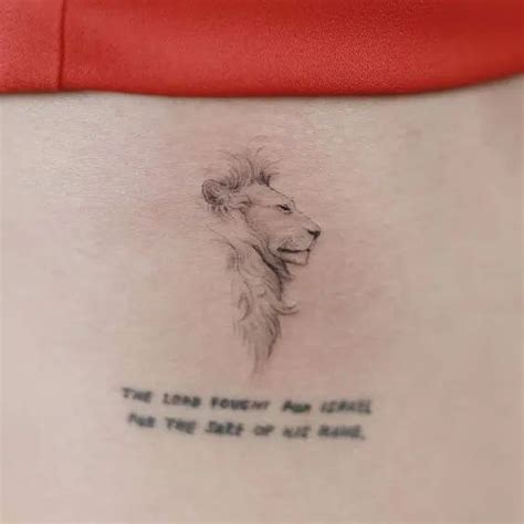 A Woman With A Tattoo On Her Stomach That Reads The Lion Power For Life