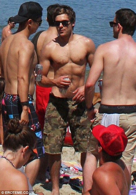 Zac Efron Flexes His Ripped Muscles At Independence Day