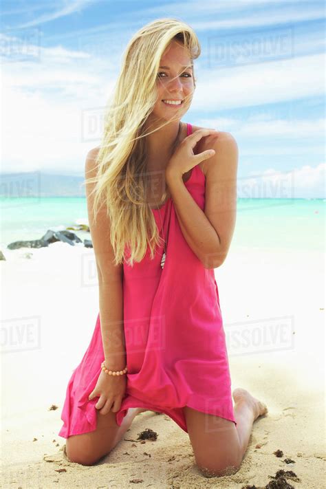 A Teenage Girl With Long Blond Hair Poses On The Beach Maui Hawaii