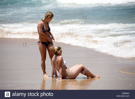 two women or girls wearing bikinis by the sea on bondi