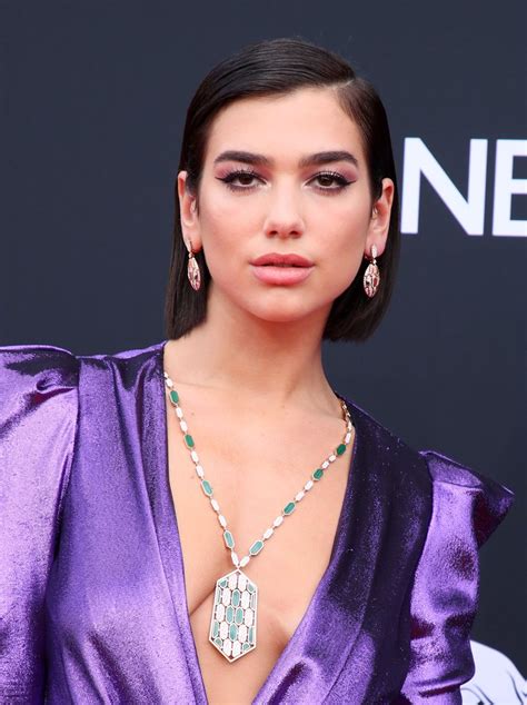 Dua Lipa Bares Cleavage In Plunging Purple Dress At The