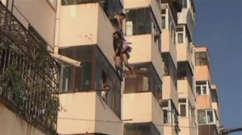 couple rescued as they fall from balcony window youtube