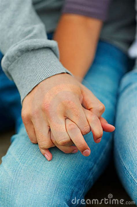 closeup of a couple holding their hands stock image