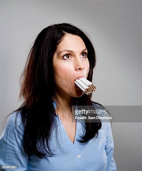 Woman Smoking Multiple Cigarettes Photos And Premium High Res Pictures
