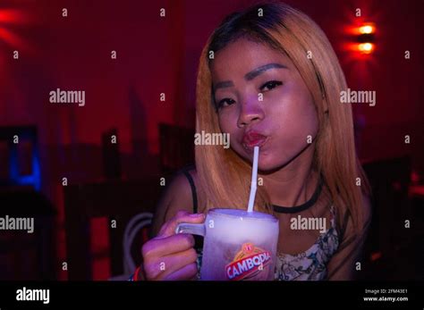 Portrait Of A Cambodian Bar Girl In A Girly Bar Drinking An Ice Cold