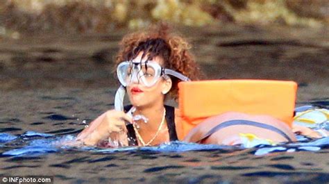 rihanna wears next to nothing on stage but covers up to go snorkelling