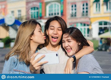 attractive beautiful asian friends women using a smartphone happy