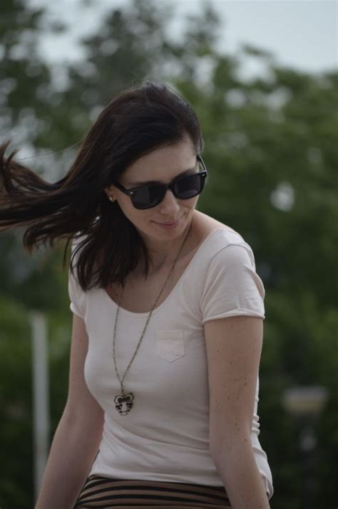 woman wearing sunglasses   white shirt  walking   hair