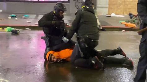 cop removes fellow cop s knee from protester s neck