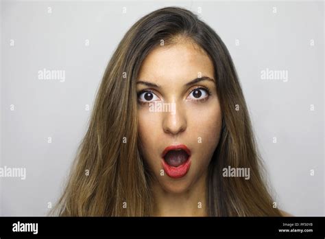 Portrait Of Surprised Young Woman With Mouth Open And Long Hair
