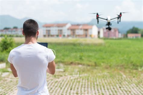 man operating  flying drone   sky stock photo image  playing innovation