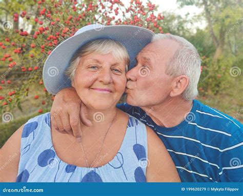 Authentic Outdoor Shot Of Aging Couple Having Fun In The Garden And