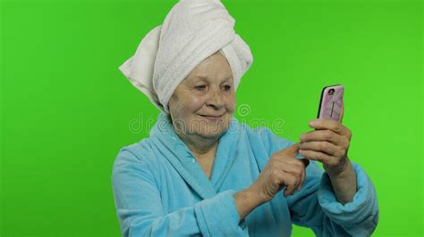 elderly grandmother after shower old woman making selfies using mobile
