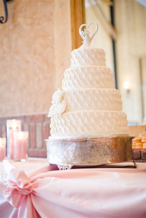 four tier ornate white buttercream cake