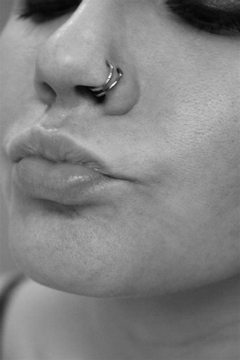 A Close Up Of A Person With A Nose Ring On Their Nose And Piercing In