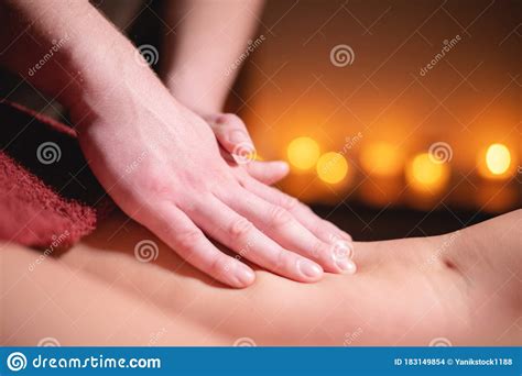 close up male hands of a professional massage therapist make