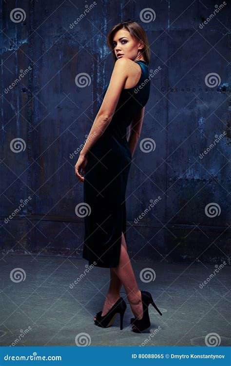 Sensual Brunette In Sling Velvet Dress Looking Over Shoulder Stock