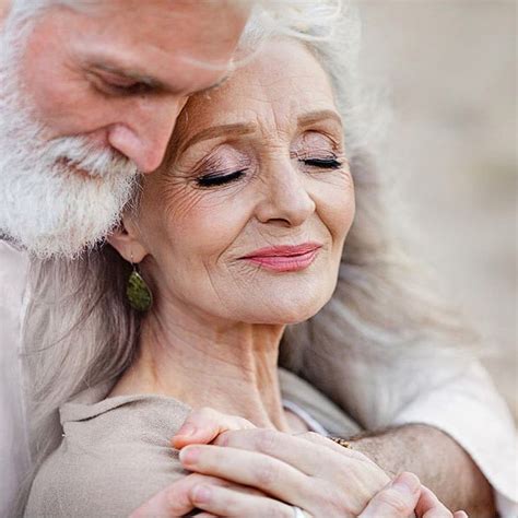 An Older Couple Embracing Each Other With Their Eyes Closed And Hands