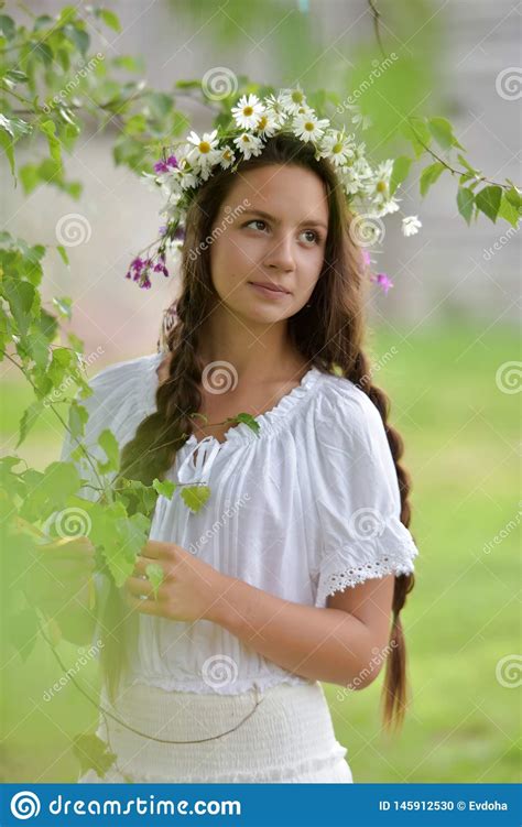 sweet russian girl girl in a white birch in the summer