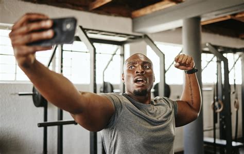 Premium Photo Gym Selfie Smartphone And Man Flexing Arm Muscle For A