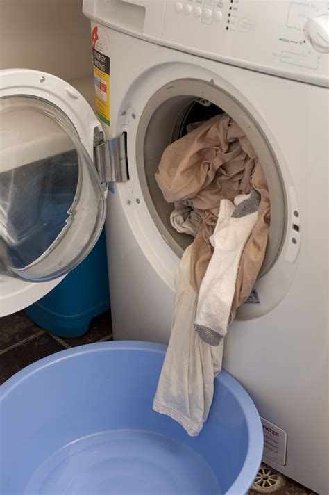 stock photo  clean washing spilling    washing machine