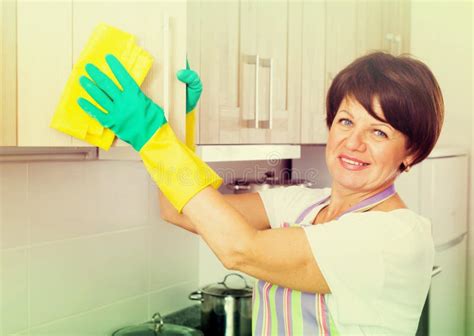 senior woman cleaning stock photo image  gloves hygiene