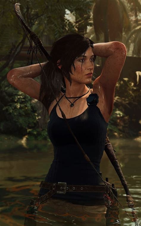 a woman in the water holding a bow and arrow with her hands behind her head