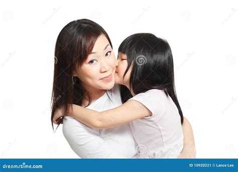 chinese girl kissing asian mother against white stock image image of