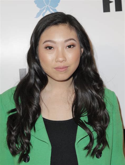 the texture and shine in awkwafina s jet black hair gives her look