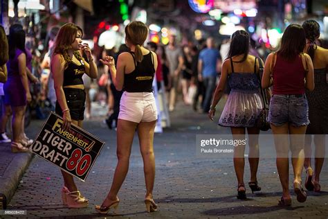 Bar Girls Hold Signs Outside Bars Along The Walking Street Where Bars
