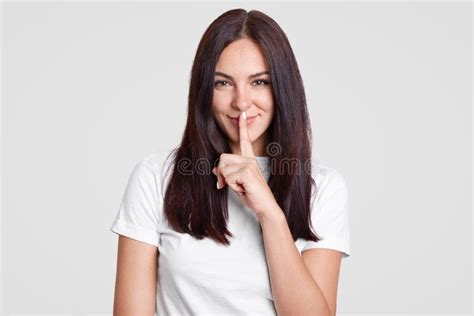 Attractive Woman With Long Dark Hair Has Secret Keeps Fore Finger Over