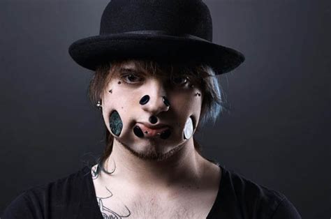 joel miggler takes body art to the extreme with giant cheek holes and