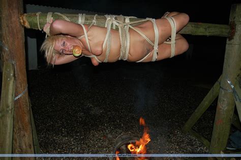 welsh slavegirl crystel lei suspended on the spitroast in bizarre outdoor bdsm porn photos