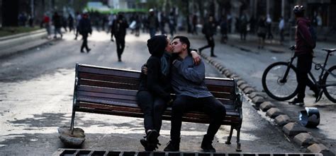 love couples kissing in the middle of protests around the world