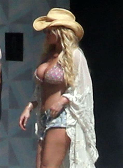 fueling boob job rumors jessica simpson spills out of her bikini in mexico