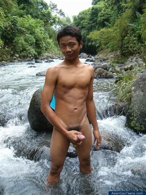 nature lover guy gets nude by rocks and water and jerks of his cock to spray cum picture 3