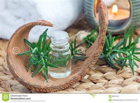 rosemary essential oil  glass  woven mat  spa background stock