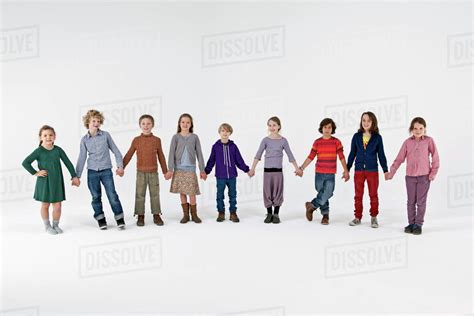 group  kids standing   row  holding hands stock photo dissolve