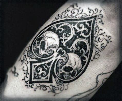 spades symbol stylized with skulls and ornaments black and white tattoo