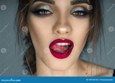 Seductive Girl Licking Her Lips And Looking At The Camera Stock Image