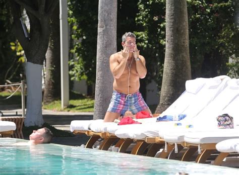 moobs in miami bravo s andy cohen caught shirtless at the swimming pool shows off bangin