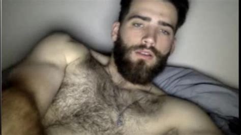 very masculine man with beard and hairy chest masturbates