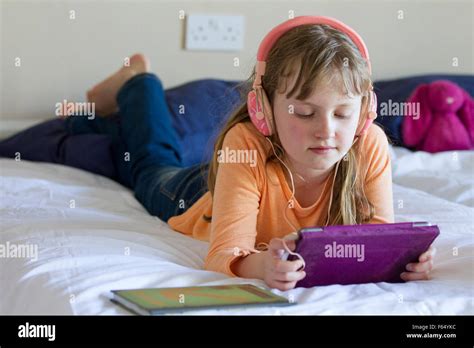 girl working  ipad mini  headphones stock photo alamy