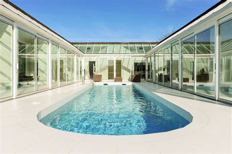 illuminated swimming pool   centrepiece   stunning  shaped house pool house plans